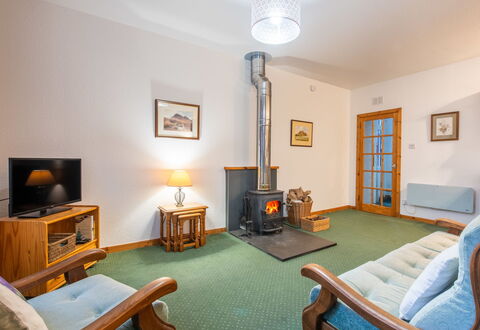 Old Stable on Aigas Golf Course: Furniture, Flooring, Interior Design, Floor, Ceiling, Room, Lighting, Living Room, Television, Couch