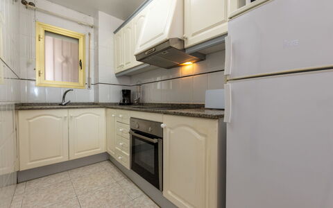 Costa Blanca: Kitchen, Kitchen Appliance, Countertop, Major Appliance, Flooring, Cabinetry, Wood, Interior Design, Kitchen Stove, Floor