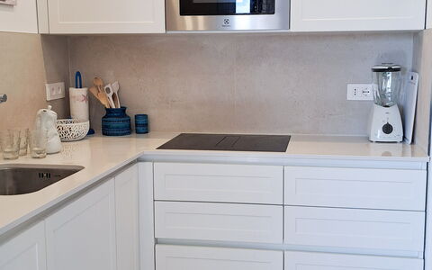 Smeralda Apartment: Cabinetry, Kitchen, Flooring, Kitchen Appliance, Wood, Countertop, Furniture, Interior Design, Floor, Major Appliance