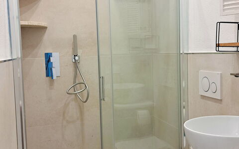 Smeralda Apartment: Bathroom, Flooring, Plumbing Fixture, Floor, Interior Design, Mirror, Toilet, Plumbing, Tile, Shower
