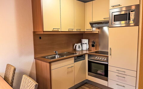 Haus 104 - Seepark Burhave: Kitchen Appliance, Furniture, Kitchen, Cabinetry, Major Appliance, Interior Design, Wood, Countertop, Flooring, Floor