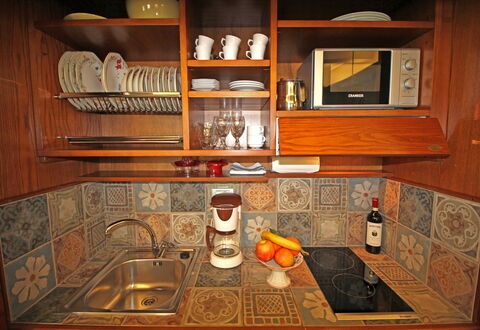 La Casa sulla Piazza: Wood, Kitchen, Interior Design, Flooring, Brown, Cabinetry, Wood Stain, Floor, Kitchen Appliance, Room
