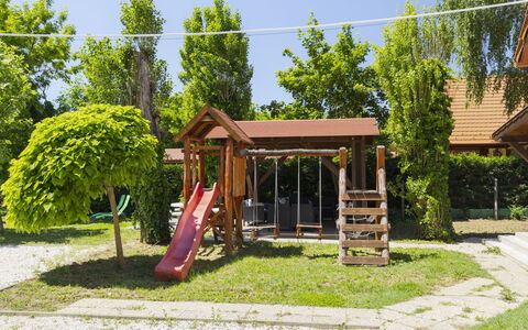 Petka: Wood, Playground Slide, Outdoor Play Equipment, Public Space, Shade, Garden, Leisure, Lawn, Backyard, Playground