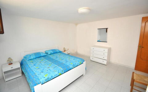Appartamento Calanca, Marina di Mancaversa: Furniture, Bed, Bedroom, Floor, Flooring, Interior Design, Wood, Bed Sheet, Bedding, Room