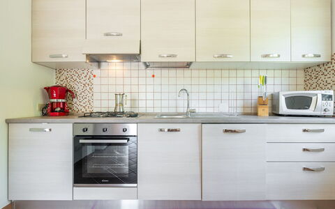 Malù House: Kitchen, Kitchen Appliance, Countertop, Cabinetry, Major Appliance, Kitchen Sink, Flooring, Sink, Furniture, Interior Design