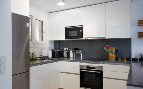 Cala Serena Village: Kitchen Appliance, Kitchen, Countertop, Cabinetry, Furniture, Interior Design, Major Appliance, Flooring, Home Appliance, Kitchen Stove