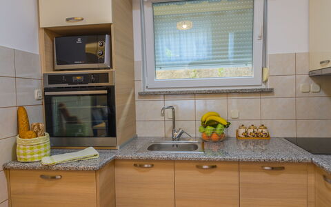 Holyday Home Midas: Kitchen, Countertop, Kitchen Appliance, Kitchen Sink, Major Appliance, Interior Design, Cabinetry, Wood, Flooring, Plumbing Fixture