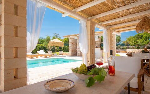 Trulli Valle D'Itria - Martina Franca: Outdoor Furniture, Swimming Pool, Resort, Chair, Shade, Estate, Patio, Design, Umbrella, Villa