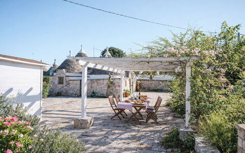 Trulli al Verde Viburno: Flagstone, Flowerpot, Garden, Shade, Outdoor Structure, Houseplant, Landscaping, Yard, Pergola, Cobblestone