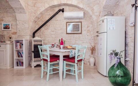 Trulli al Verde Viburno: Furniture, Interior Design, Chair, Table, Flooring, Kitchen & Dining Room Table, Apartment, Dining Room, Ceiling, Stone Wall