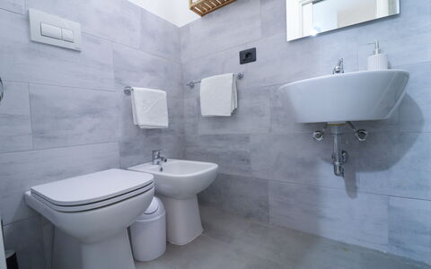 Malika: Bathroom, Flooring, Plumbing Fixture, Floor, Toilet Seat, Sink, Bathroom Sink, Toilet, Interior Design, Tap