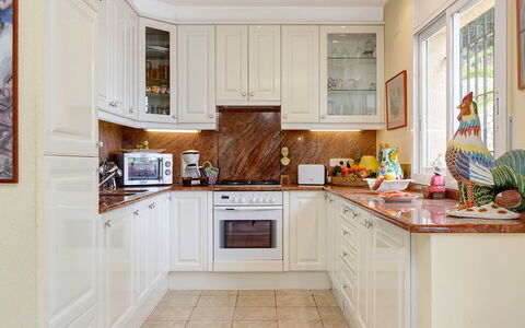 Villa Muneca: Kitchen, Kitchen Appliance, Countertop, Cabinetry, Major Appliance, Interior Design, Furniture, Flooring, Home, Lighting