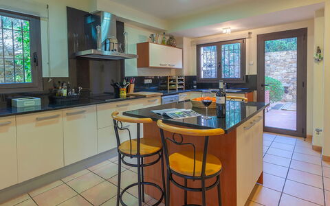 Villa Tamariu: Kitchen, Countertop, Kitchen Appliance, Furniture, Cabinetry, Interior Design, Major Appliance, Flooring, Wood, Home Appliance