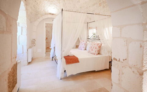 Trulli Heaven: Wall, Furniture, Floor, Bedroom, Ceiling, Bed, Stone Wall, Linens, Bedding, Bed Sheet