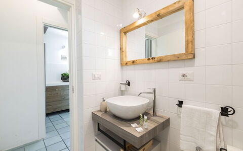 Villa Riva: Interior Design, Bathroom, Bathroom Sink, Flooring, Plumbing Fixture, Floor, Wood, Sink, Mirror, Tap