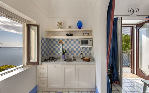 Little Mansour: Furniture, Chair, Tile, Houseplant, Wood Stain, Kitchen & Dining Room Table, Kitchen, Cabinetry, Countertop, Home Door
