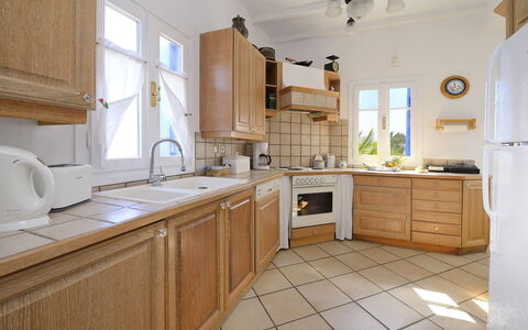 Villa Sesilia: Kitchen, Cabinetry, Countertop, Kitchen Appliance, Furniture, Interior Design, Flooring, Major Appliance, Floor, Cupboard
