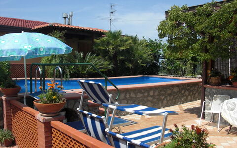 Villa Due Golfi: Furniture, Swimming Pool, Outdoor Furniture, Flowerpot, Resort, Chair, Shade, Eco Hotel, Houseplant, Umbrella