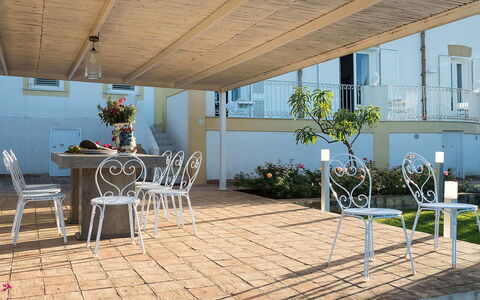 The Flower Garden: Furniture, Floor, Flooring, Outdoor Furniture, Shade, Outdoor Table, Chair, Outdoor Structure, Porch, Flowerpot