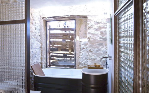 Villa Cave: Wall, Plumbing Fixture, Flooring, Bathroom, Interior Design, Lighting, Floor, Composite Material, Plumbing, Bathtub