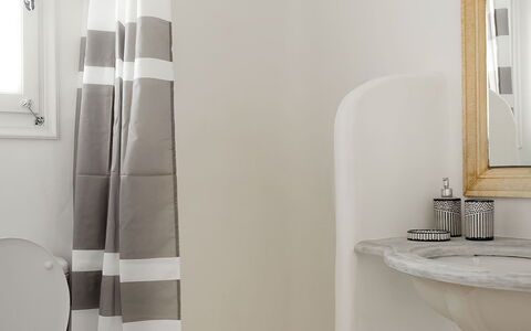 Mykonos Pool House 7: White, Bathroom, Interior Design, Floor, Flooring, Toilet Seat, Toilet, Plumbing Fixture, Shower Curtain, Towel