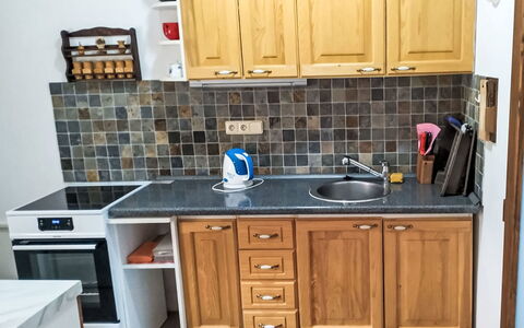U Kohouta: Kitchen, Countertop, Cabinetry, Flooring, Kitchen Appliance, Wood, Major Appliance, Furniture, Cupboard, Floor
