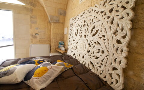 Coclea Heritage Suites: Bedroom, Bedding, Bed Sheet, Linens, Bed, Bed Frame, Pillow, Wood Stain, Design, Throw Pillow