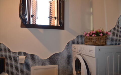 Appartamento Tamara, Budoni: Interior Design, Lighting, Room, Washing Machine, Laundry Room, Plumbing Fixture, Mirror, Plumbing, Clothes Dryer, Light Fixture