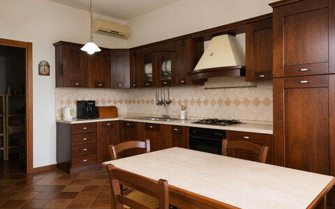 Villa Margi: Flooring, Furniture, Wood, Interior Design, Kitchen, Cabinetry, Floor, Countertop, Cupboard, Brown