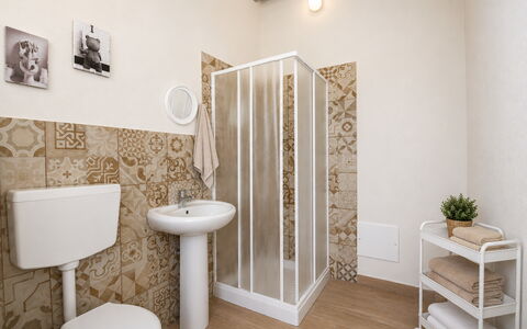 Villa Cosentini: Flooring, Floor, Plumbing Fixture, Bathroom, Tile, Toilet Seat, Toilet, Wallpaper, Plumbing