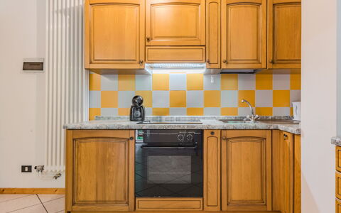 Malè 100: Kitchen, Countertop, Flooring, Wood, Yellow, Major Appliance, Interior Design, Kitchen Appliance, Floor, Cabinetry
