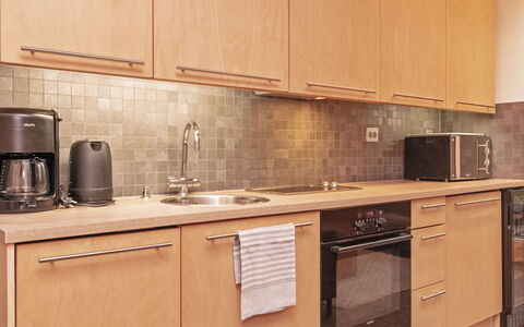 Villa Sinikka 1: Countertop, Kitchen, Kitchen Appliance, Cabinetry, Major Appliance, Wood, Kitchen Sink, Sink, Plumbing Fixture, Flooring