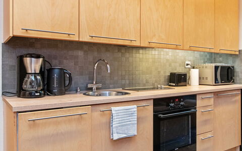 Villa Hanna: Kitchen Appliance, Kitchen, Countertop, Major Appliance, Cabinetry, Furniture, Wood, Kitchen Sink, Flooring, Interior Design