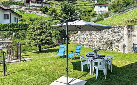 Riflessi del Lario: Umbrella, Outdoor Furniture, Furniture, Shade, Outdoor Table, Chair, Pole, Mountain Range, Lawn, Garden
