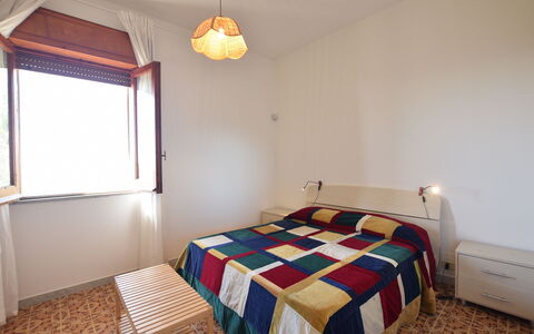 Punta Braccetto Fronte Mare: Bed, Bedroom, Wall, Interior Design, Floor, Bed Sheet, Wood, Flooring, Bedding, Room