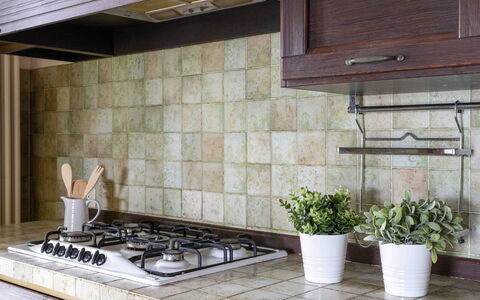 Casa Dolceconero: Kitchen, Flooring, Countertop, Kitchen Appliance, Tile, Stove, Gas Stove, Kitchen Stove, Natural Material, Cooktop