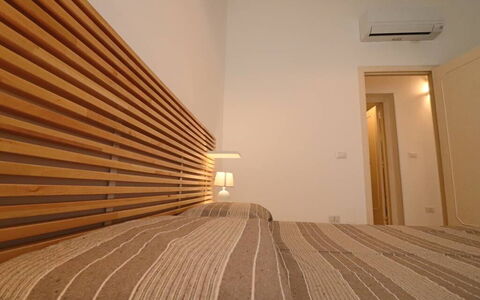 Nausica: Wood, Interior Design, Bed, Bedroom, Furniture, Textile, Floor, Bed Sheet, Lighting, Bedding
