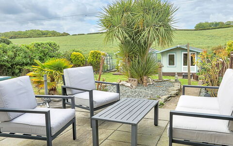 Shoe Buttons Cottage at Gap Road: Furniture, Outdoor Furniture, Chair, Garden, Patio, Outdoor Table, Flowerpot, Armrest, Houseplant, Backyard