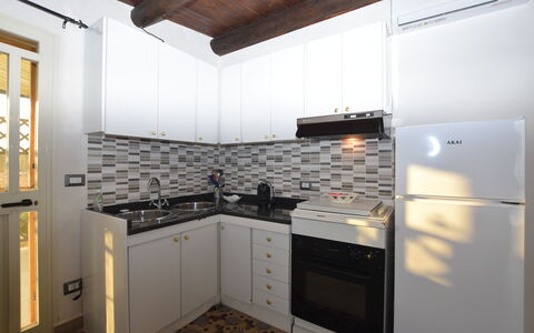 Villa Cigno Reale: Kitchen, Kitchen Appliance, Countertop, Major Appliance, Interior Design, Cabinetry, Flooring, Wood, Kitchen Stove, Furniture