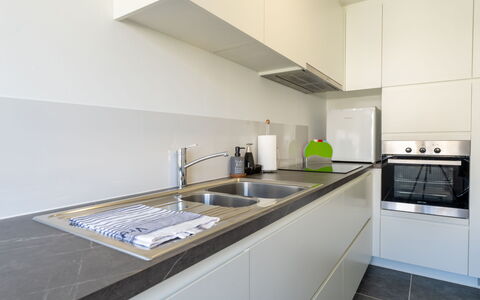 Centrally Located The Corner: Kitchen, Countertop, Kitchen Appliance, Interior Design, Flooring, Major Appliance, Cabinetry, Wood, Kitchen Sink, Floor