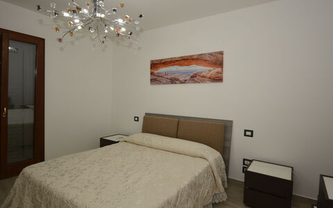 Villa Monaco: Bed, Bedroom, Bed Sheet, Bedding, Interior Design, Wood, Furniture, Floor, Linens, Bed Frame