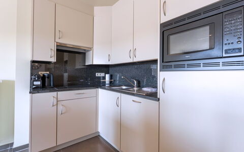 Residentie Casa Nova: Countertop, Interior Design, Kitchen, Flooring, Cabinetry, Major Appliance, Floor, Kitchen Appliance, Room, Sink