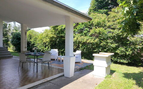 Villa Eva: Column, Shade, Concrete, Porch, Garden, Outdoor Structure, Lawn, Backyard, Landscaping, Yard