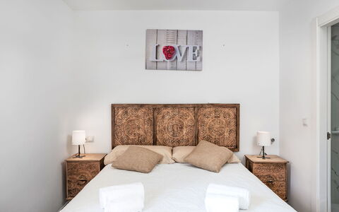 Las Naciones: Bed, Bedding, Bedroom, Furniture, Bed Sheet, Wall, Interior Design, Wood, Linens, Floor
