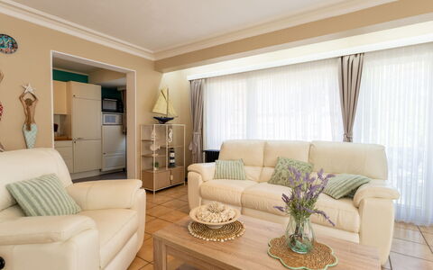 Centrally Located Sea You Again: Furniture, Interior Design, Couch, Flooring, Floor, Room, Ceiling, Living Room, Wood, Home