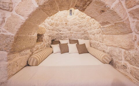 Trulli Biancapetra 8+2: Wall, Bedroom, Interior Design, Furniture, Bed, Floor, Lighting, Pillow, Flooring, Room