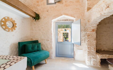Masseria Grotta Antica 6+2: Wall, Chair, Stone Wall, Natural Material, Houseplant, Plaster, Living Room, Coffee Table