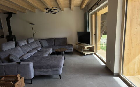 Ferienwohnung Schof: Wood, Flooring, Floor, Furniture, Couch, Living Room, Ceiling, Hardwood, Chair
