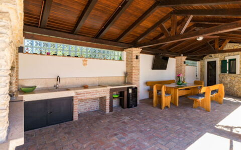 Villa Dominique: Ceiling, Shade, Countertop, Resort, Chair, Kitchen, Wood Stain, Brick, Tile, Outdoor Structure