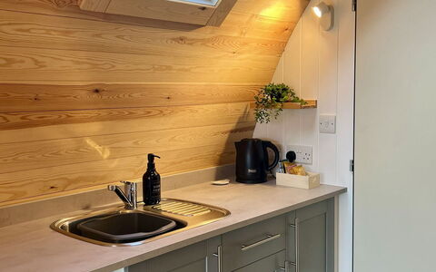 Whinfell Pod: Wood, Flooring, Wood Stain, Countertop, Plumbing Fixture, Kitchen, Kitchen Appliance, Hardwood, Plumbing, Major Appliance
